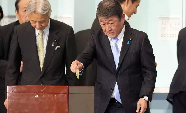 One of candidates, Toshimitsu Motegi, right, casts his ballot at the ruling Liberal Democratic Party's (LDP) leadership election Friday, Sept. 27, 2024, in Tokyo. (AP Photo/Hiro Komae, Pool)