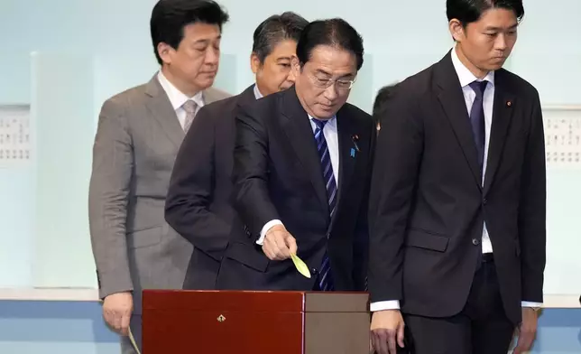 Japan's Prime Minister Fumio Kishida, center, casts his ballot at the Liberal Democratic Party's (LDP) leadership election Friday, Sept. 27, 2024, in Tokyo. (AP Photo/Hiro Komae, Pool)