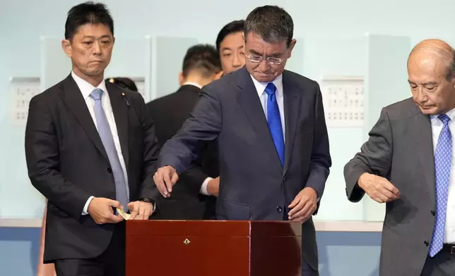 One of candidates Taro Kono, center, casts his ballot at the ruling Liberal Democratic Party's (LDP) leadership election Friday, Sept. 27, 2024, in Tokyo. (AP Photo/Hiro Komae, Pool)