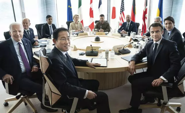 FILE - Ukrainian President Volodymyr Zelenskyy, center rear, joins G7 world leaders at a working session on the final day of the G7 Summit in Hiroshima, Japan, on May 21, 2023. From left to right are: Japan's Prime Minister Fumio Kishida, U.S. President Joe Biden, German Chancellor Olaf Scholz, Britain's Prime Minister Rishi Suna, European Commission President Ursula von der Leyen, Zelenskyy, European Council President Charles Michel, Gianluigi Benedetti, Italian ambassador to Japan, Canada's Prime Minister Justin Trudeau, and France's President Emmanuel Macron. (Stefan Rousseau/Pool Photo via AP, File)