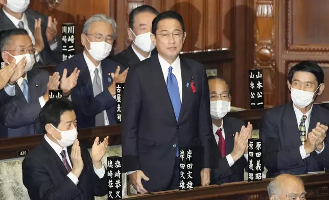 FILE - Fumio Kishida, center, is applauded after being named as Japan's prime minister at the parliament's lower house in Tokyo on Oct. 4, 2021. (Kyodo News via AP, File)