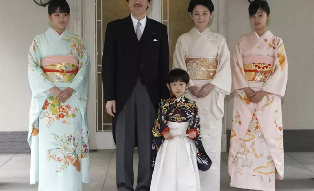 FILE - Japan's Prince Hisahito, wearing a traditional ceremonial attire, is accompanied by his parents, Prince Akishino, Princess Kiko, his sisters Princess Mako, left, and Princess Kako, right, after attending "Chakko-no-gi" ceremony to celebrate his growth and the passage from infancy to childhood, at the Akasaka imperial estate in Tokyo, Nov. 3, 2011. (AP Photo/Issei Kato, Pool, File)