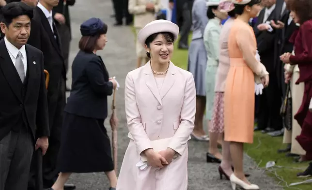 FILE- Japan's Princess Aiko greets guests during the spring garden party at the Akasaka Palace imperial garden Tuesday, April 23, 2024, in Tokyo. (AP Photo/Eugene Hoshiko, File)