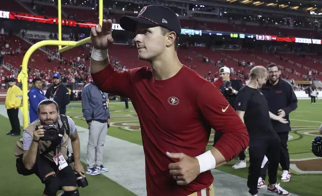 San Francisco 49ers quarterback Brock Purdy, center, gestures toward fans after an NFL football game against the New York Jets in Santa Clara, Calif., Monday, Sept. 9, 2024. (AP Photo/Jed Jacobsohn)