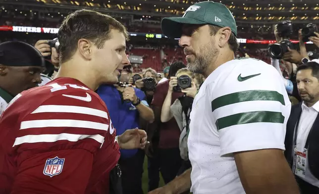 San Francisco 49ers quarterback Brock Purdy, left, talks with New York Jets quarterback Aaron Rodgers, right, after an NFL football game in Santa Clara, Calif., Monday, Sept. 9, 2024. (AP Photo/Jed Jacobsohn)