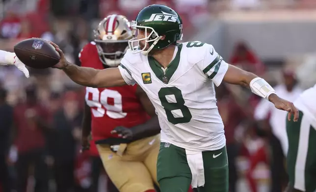 New York Jets quarterback Aaron Rodgers (8) passes the ball as San Francisco 49ers defensive tackle Maliek Collins (99) applies pressure during the first half of an NFL football game in Santa Clara, Calif., Monday, Sept. 9, 2024. (AP Photo/Jed Jacobsohn)