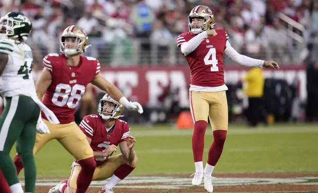 San Francisco 49ers place-kicker Jake Moody (4) watches his field goal with Jake Tonges (88) and Mitch Wishnowsky (3) during the second half of an NFL football game against the New York Jets in Santa Clara, Calif., Monday, Sept. 9, 2024. (AP Photo/Godofredo A. Vásquez)