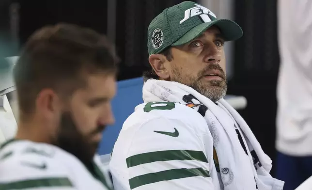 New York Jets quarterback Aaron Rodgers, right, sits on the bench during the second half of an NFL football game against the San Francisco 49ers in Santa Clara, Calif., Monday, Sept. 9, 2024. (AP Photo/Jed Jacobsohn)