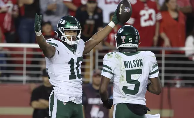 New York Jets wide receiver Allen Lazard (10) celebrates with wide receiver Garrett Wilson (5) after scoring against the San Francisco 49ers during the second half of an NFL football game in Santa Clara, Calif., Monday, Sept. 9, 2024. (AP Photo/Jed Jacobsohn)