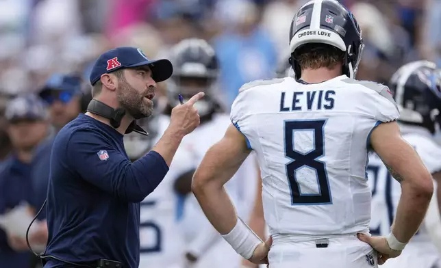 Tennessee Titans coach Brian Callahan speaks with Tennessee Titans quarterback Will Levis (8) in the first half of an NFL football game against the New York Jets in Nashville, Tenn., on Sunday, Sept. 15, 2024. (AP Photo/George Walker IV)