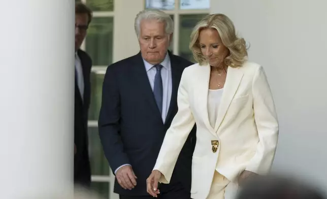 First lady Jill Biden, with actor Martin Sheen, and other members of the cast of The West Wing, walk to the stage during an event on the Rose Garden at the White House marking the 25th anniversary of the television series, The West Wing, Friday, Sept. 20, 2024, in Washington. (AP Photo/Manuel Balce Ceneta)