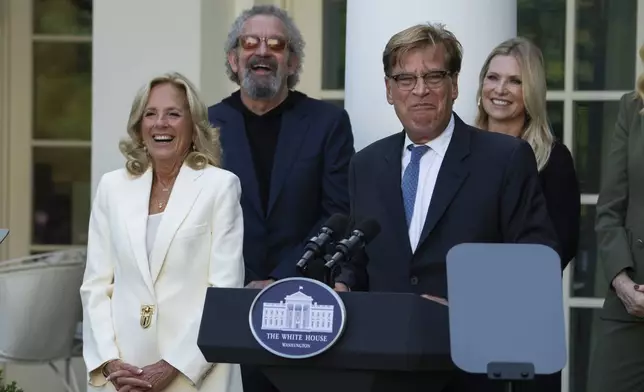 First lady Jill Biden, listens to Aaron Sorkin speak at an event on the Rose Garden at the White House to mark the 25th anniversary of the television series, The West Wing, Friday, Sept. 20, 2024, in Washington. (AP Photo/Manuel Balce Ceneta)