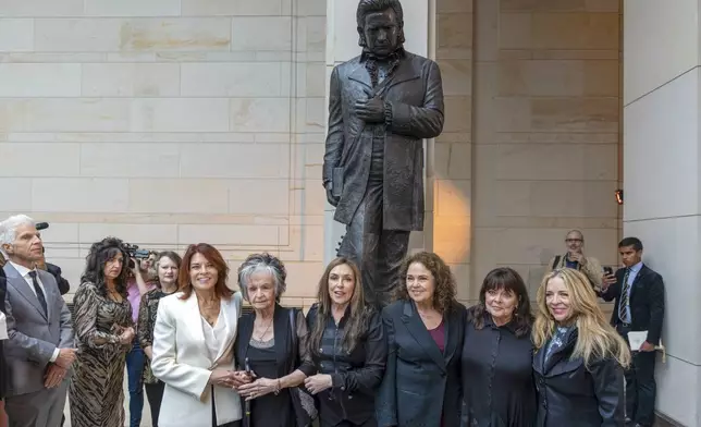 From left to right, relatives of Johnny Cash daughter Rosanne Cash, sister Joanne Cash, daughter Cindy Cash, daughter Tara Cash Schwoebel, daughter Kathy Cash, and stepdaughter Carlene Carter, pose in front of the unveiled bronze statue of singer Johnny Cash, in Emancipation Hall at the Capitol in Washington, Tuesday, Sept. 24, 2024. (AP Photo/Ben Curtis)