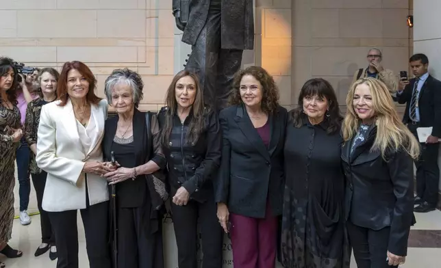 From left to right, relatives of Johnny Cash daughter Rosanne Cash, sister Joanne Cash, daughter Cindy Cash, daughter Tara Cash Schwoebel, daughter Kathy Cash, and stepdaughter Carlene Carter, pose in front of the unveiled bronze statue of singer Johnny Cash, created by Little Rock sculptor Kevin Kresse, in Emancipation Hall at the Capitol in Washington, Tuesday, Sept. 24, 2024. (AP Photo/Ben Curtis)