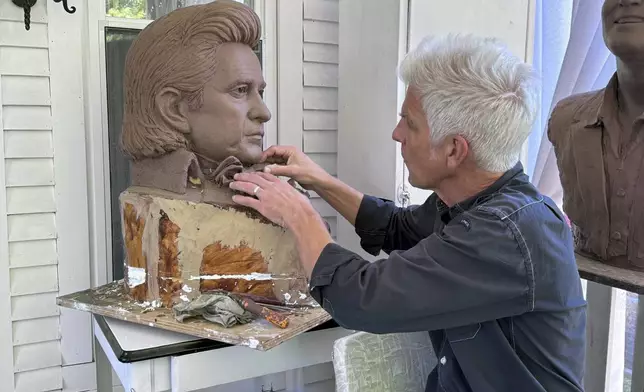 FILE - Artist Kevin Kresse, works on a clay bust of Johnny Cash, April 23, 2024 in Little Rock, Ark. Kresse's full sculpture of Cash will be unveiled at the U.S. Capitol as part of the Statuary Hall collection. (AP Photo/Mike Pesoli, File)