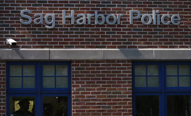 A police officer stands inside the Sag Harbor Police station during Justin Timberlake's hearing, Friday, Sept. 13, 2024, in Sag Harbor, N.Y. (AP Photo/Pamela Smith)