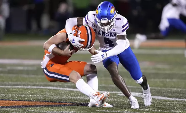 Kansas safety Marvin Grant sacks Illinois quarterback Luke Altmyer during the second half of an NCAA college football game Saturday, Sept. 7, 2024, in Champaign, Ill. (AP Photo/Charles Rex Arbogast)