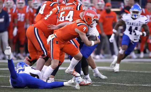 Illinois quarterback Luke Altmyer steps away from Kansas defensive end DJ Warner during the first half of an NCAA college football game Saturday, Sept. 7, 2024, in Champaign, Ill. (AP Photo/Charles Rex Arbogast)