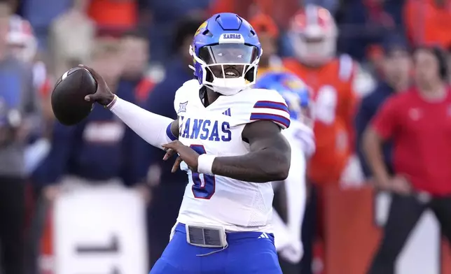 Kansas quarterback Jalon Daniels passes during the first half of an NCAA college football game against Illinois on Saturday, Sept. 7, 2024, in Champaign, Ill. (AP Photo/Charles Rex Arbogast)