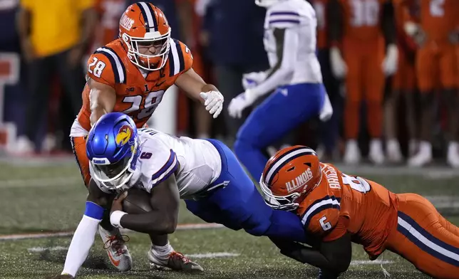 Illinois defensive lineman Dennis Briggs Jr., right, and linebacker Dylan Rosiek tackle Kansas quarterback Jalon Daniels for a loss during the second half of an NCAA college football game Saturday, Sept. 7, 2024, in Champaign, Ill. (AP Photo/Charles Rex Arbogast)