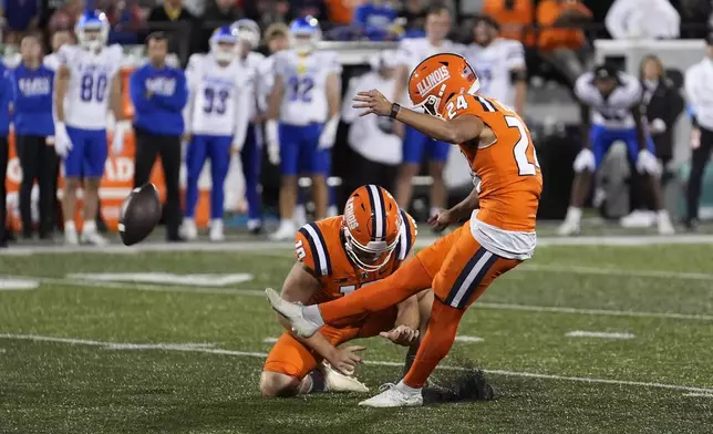 Illinois place kicker David Olano, right, kicks a field goal late in the fourth quarter off the hold of Hugh Robertson during the second half of an NCAA college football game against Kansas on Saturday, Sept. 7, 2024, in Champaign, Ill. (AP Photo/Charles Rex Arbogast)