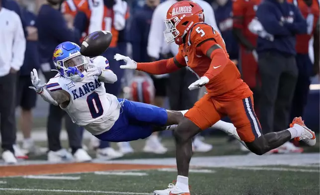 Kansas wide receiver Quentin Skinner is unable to catch a pass from quarterback Jalon Daniels as Illinois defensive back Torrie Cox Jr. defends during the first half of an NCAA college football game Saturday, Sept. 7, 2024, in Champaign, Ill. (AP Photo/Charles Rex Arbogast)