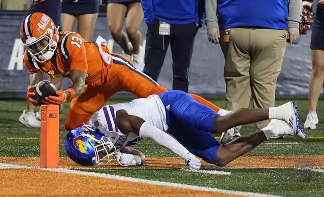 Kansas safety O.J. Burroughs, right, keeps Illinois wide receiver Pat Bryant out of the end zone off a pass from quarterback Luke Altmyer during the second half of an NCAA college football game Saturday, Sept. 7, 2024, in Champaign, Ill. (AP Photo/Charles Rex Arbogast)