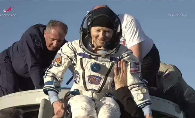 In this photo taken from video released by Roscosmos space corporation, rescue team members help NASA astronaut Tracy Dyson to leave the capsule shortly after the landing of the Russian Soyuz MS-25 space capsule carrying the NASA astronaut Tracy Dyson and the Roscosmos cosmonauts Oleg Kononenko and Nikolai Chub, south-east of the Kazakh town of Zhezkazgan, Kazakhstan, Monday, Sept. 23, 2024. (Roscosmos space corporation via AP)