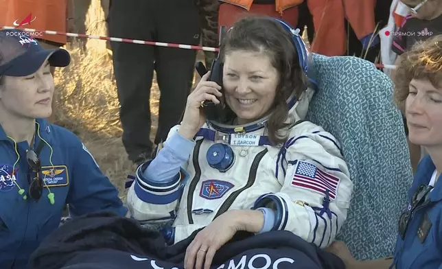 In this photo taken from video released by Roscosmos space corporation, the NASA astronaut Tracy Dyson speaks on a phone shortly after the landing of the Russian Soyuz MS-25 space capsule carrying the NASA astronaut Tracy Dyson and the Roscosmos cosmonauts Oleg Kononenko and Nikolai Chub, south-east of the Kazakh town of Zhezkazgan, Kazakhstan, Monday, Sept. 23, 2024. (Roscosmos space corporation via AP)