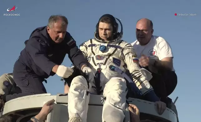 In this photo taken from video released by Roscosmos space corporation, rescue team members help Roscosmos cosmonaut Nikolai Chub to get from the capsule shortly after the landing of the Russian Soyuz MS-25 space capsule carrying NASA astronaut Tracy Dyson, Roscosmos cosmonauts Oleg Kononenko and Nikolai Chub, south-east of the Kazakh town of Zhezkazgan, Kazakhstan, Monday, Sept. 23, 2024. (Roscosmos space corporation via AP)