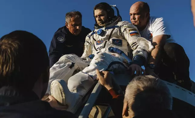 In this photo released by Roscosmos space corporation, rescue team members help Roscosmos cosmonaut Nikolai Chub to get from the capsule shortly after the landing of the Russian Soyuz MS-25 space capsule carrying NASA astronaut Tracy Dyson, Roscosmos cosmonauts Oleg Kononenko and Nikolai Chub, south-east of the Kazakh town of Zhezkazgan, Kazakhstan, Monday, Sept. 23, 2024. (Ivan Timoshenko, Roscosmos space corporation via AP)