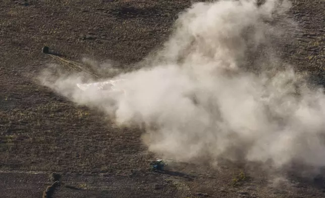 In this photo released by Roscosmos space corporation, a tractor is seen in the foreground at the site of landing of Russian Soyuz MS-25 space capsule carrying NASA astronaut Tracy Dyson, Roscosmos cosmonauts Oleg Kononenko and Nikolai Chub, south-east of the Kazakh town of Zhezkazgan, Kazakhstan, Monday, Sept. 23, 2024. (Ivan Timoshenko, Roscosmos space corporation via AP)