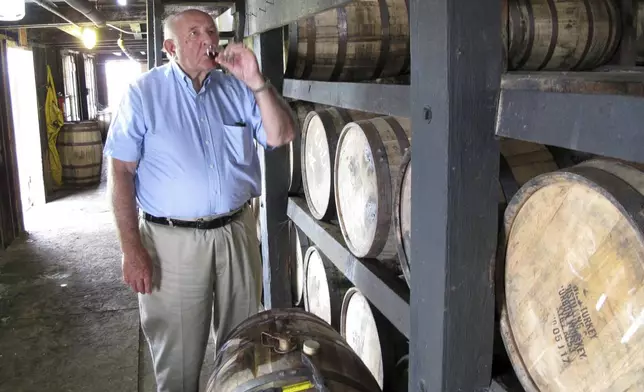 FILE- Wild Turkey master distiller Jimmy Russell takes a sip of bourbon drawn from the barrel at a warehouse near Lawrenceburg, Ky., Aug. 22, 2014. (AP Photo/Bruce Schreiner, File)