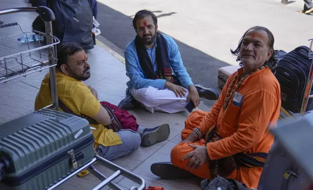 Stranded passengers wait for their delayed flights out of JKIA airport after flights were grounded following workers’ protesting a planned deal between the government and a foreign investor, in Nairobi, Kenya, Wednesday, Sept. 11, 2024. (AP Photo/Brian Inganga)