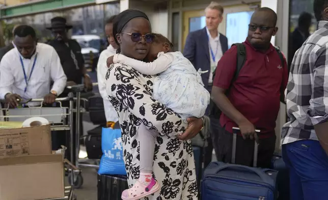 Stranded passengers wait for their delayed flights out of JKIA airport after flights were grounded following workers’ protesting a planned deal between the government and a foreign investor, in Nairobi, Kenya, Wednesday, Sept. 11, 2024. (AP Photo/Brian Inganga)