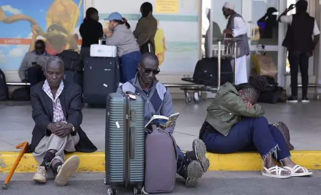 Stranded passengers wait for their delayed flights out of JKIA airport after flights were grounded following workers’ protesting a planned deal between the government and a foreign investor, in Nairobi, Kenya, Wednesday, Sept. 11, 2024. (AP Photo/Brian Inganga)