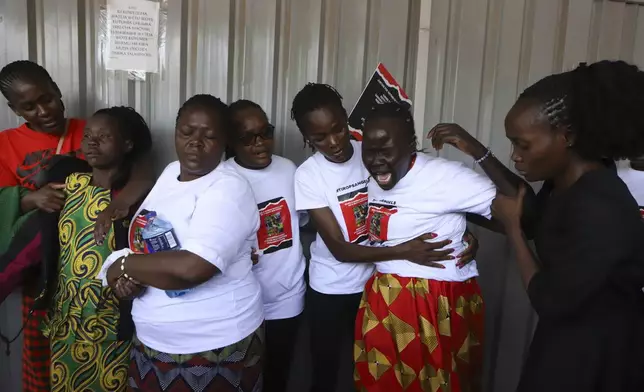 Relatives try to comfort a woman crying after viewing the body of Ugandan Olympic athlete Rebecca Cheptegei at Moi Teaching and Referral Hospital morgue in the western city of Eldoret, in Rift Valley, Kenya Friday, Sept. 13, 2024. (AP Photo/Andrew Kasuku)