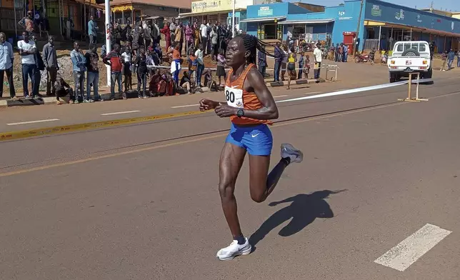 FILE -Rebecca Cheptegei, competes at the Discovery 10km road race in Kapchorwa, Uganda, Jan. 20, 2023. (AP Photo, File)