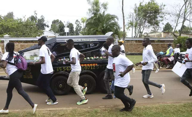 Members of the public escort a hearse carrying the coffin of Ugandan Olympic athlete Rebecca Cheptegei in the western city of Eldoret, in Rift Valley, Kenya Friday, Sept. 13, 2024. (AP Photo/Andrew Kasuku)