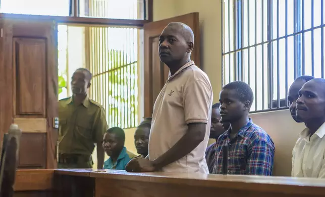 FILE - Extremist evangelical leader Paul Mackenzie, who was arrested on suspicion of telling his followers to fast to death in order to meet Jesus, appears at a court accompanied by some of his followers in Malindi, Kenya on Monday, April 17, 2023. (AP Photo/File)