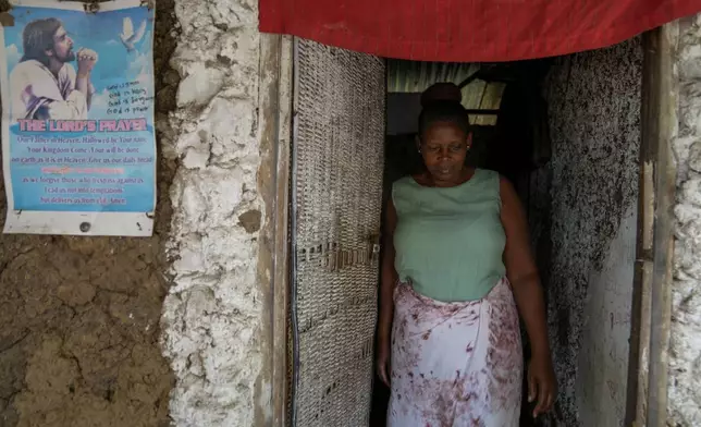 Priscillar Riziki, whose daughter and three grandchildren are believed to have been among the victims of the Good News International Church cult, walks out of her house in the coastal city of Malindi, in southern Kenya, on Saturday, Sept. 7, 2024. (AP Photo/Brian Inganga)