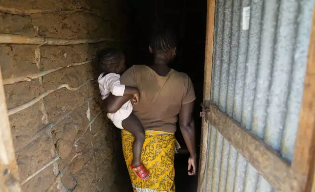 A woman who escaped the Good News International Church in Shakahola after she said she was sexually assaulted, enters a house in the coastal city of Malindi, in southern Kenya, on Friday, Sept. 6, 2024. (AP Photo/Brian Inganga)