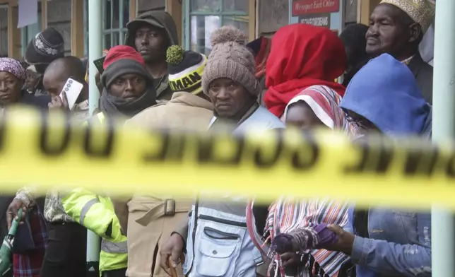 Distressed parents stand near a burnt-out dormitory, following a fire at the Hillside Endarasha Primary in Nyeri, Kenya Friday, Sep. 6, 2024. (AP Photo)