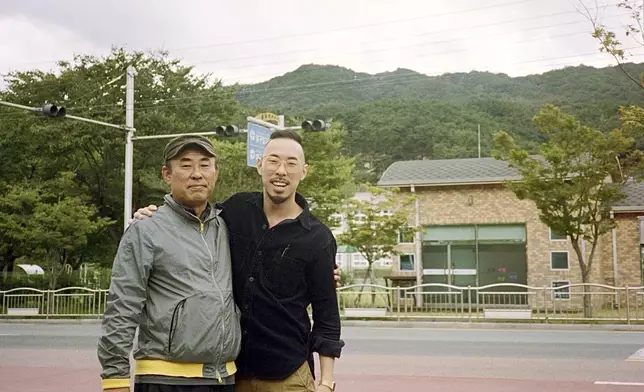 In this photo provided by Robert Calabretta, right, he and and his biological father, Lee Sung-soo, stand together for a photo while on a visit in Daegu, South Korea, in August of 2020, during the COVID-19 pandemic. (Courtesy Robert Calabretta via AP)