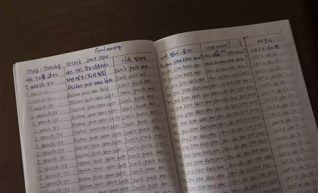 Han Tae-soon's notebook sits on a table at her home in Anyang, South Korea, Saturday, June 1, 2024. Han, who is in her 70s, has notebooks feverishly annotated with English translations, written during countless hours trying to learn her daughter's language. (AP Photo/Jae C. Hong)