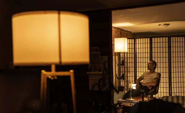 Robert Calabretta, who was adopted as a baby out of South Korea to an American family, sits in his apartment, Thursday, Feb. 15, 2024, in New York. (AP Photo/David Goldman)