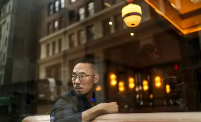 Robert Calabretta sits for a portrait at the restaurant where he works, Thursday, Feb. 15, 2024, in New York. (AP Photo/David Goldman)