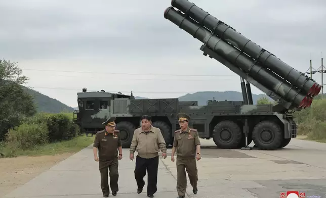 In this undated photo provided on Friday, Sept. 13, 2024, by the North Korean government, its leader Kim Jong Un, center, walks with other officials near what it says is their new launch vehicle of 600mm multiple rockets at an undisclosed location in North Korea. Independent journalists were not given access to cover the event depicted in this image distributed by the North Korean government. The content of this image is as provided and cannot be independently verified. Korean language watermark on image as provided by source reads: "KCNA" which is the abbreviation for Korean Central News Agency. (Korean Central News Agency/Korea News Service via AP)