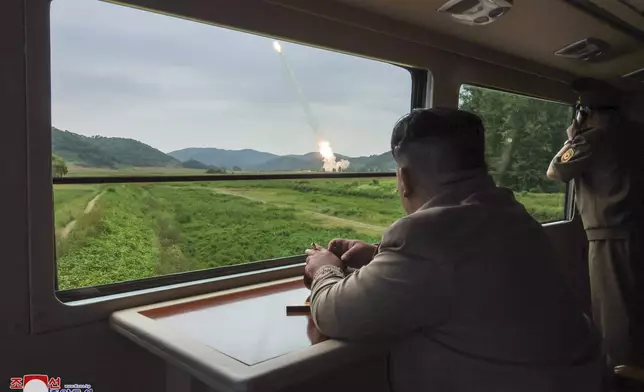 In this undated photo provided on Friday, Sept. 13, 2024, by the North Korean government, its leader Kim Jong Un, center right, inspects what they say is test-firing from their new launch vehicle of 600mm multiple rockets at an undisclosed location in North Korea. Independent journalists were not given access to cover the event depicted in this image distributed by the North Korean government. The content of this image is as provided and cannot be independently verified. Korean language watermark on image as provided by source reads: "KCNA" which is the abbreviation for Korean Central News Agency. (Korean Central News Agency/Korea News Service via AP)