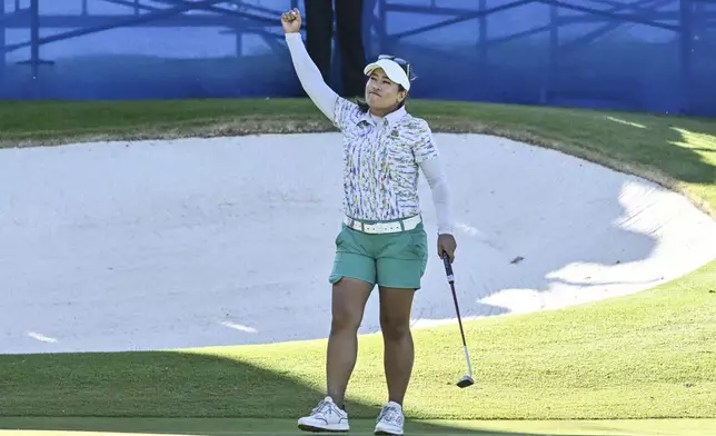 Jasmine Suwannapura, of Thailand, celebrates after sinking the winning putt in the second playoff round on the 18th hole during the final round of the LPGA Walmart NW Arkansas Championship golf tournament, Sunday, Sept. 29, 2024, in Rogers, Ark. (AP Photo/Michael Woods)